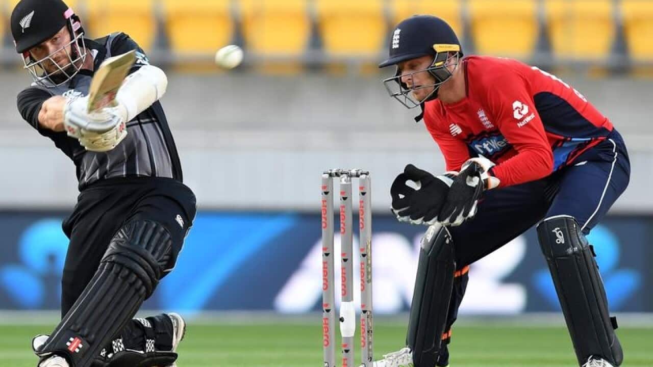 Kane Williamson of New Zealand (left) sweeps in front of Jos Buttler.