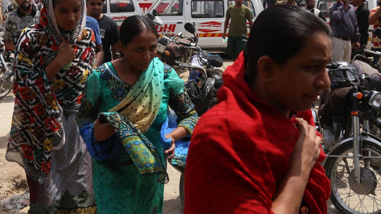 Relatives of victims who were killed in a gun fire at a bus in Karachi