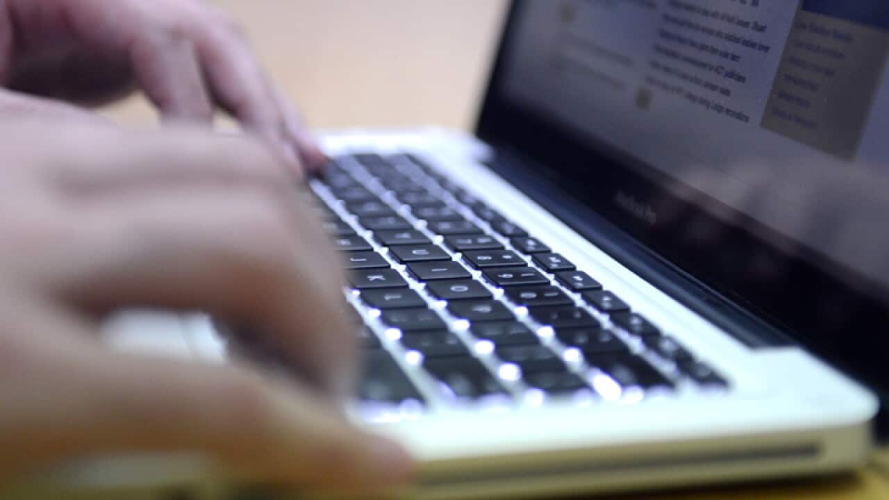 A man uses a laptop computer