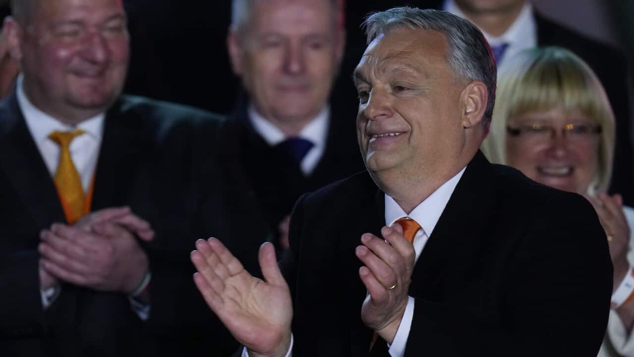 Hungary's Prime Minister Viktor Orban acknowledges cheering supporters during an election night rally in Budapest on 3 April 2022.