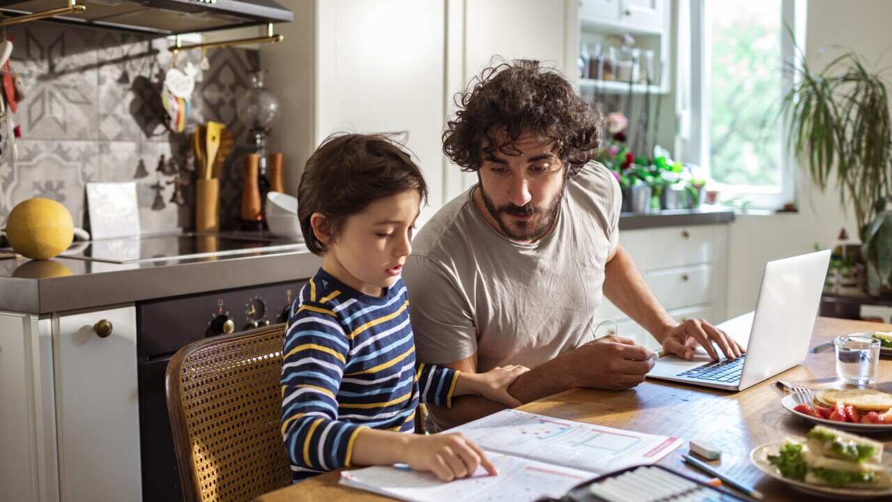 Father helping his son with schoolwork