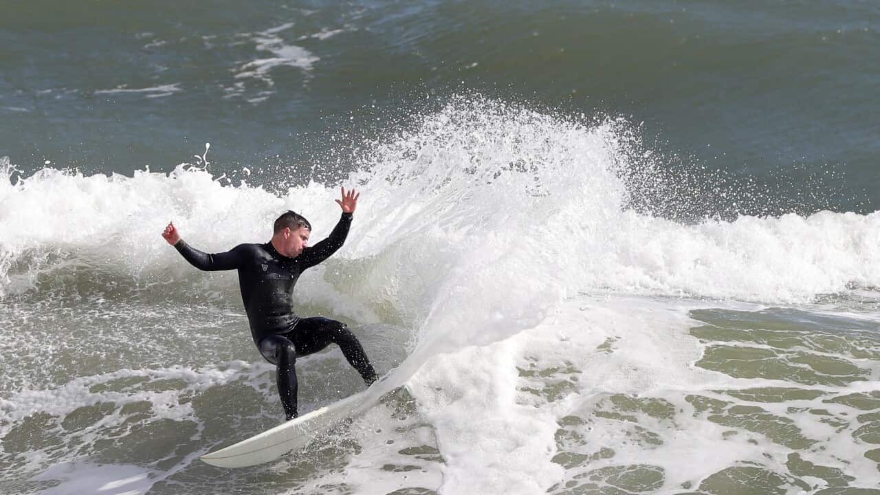 A surfer is seen in action at Cottesloe Beach in Perth, Tuesday, July 27, 2021.