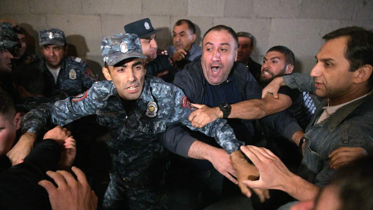 A soldier attempting to control violent protestors.