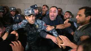 A soldier attempting to control violent protestors.