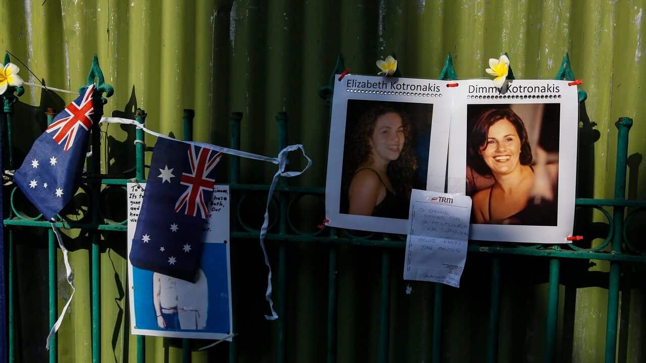 Pictures of 2002 Bali bomb victims are attached on a fence at the former site of the Sari Club.