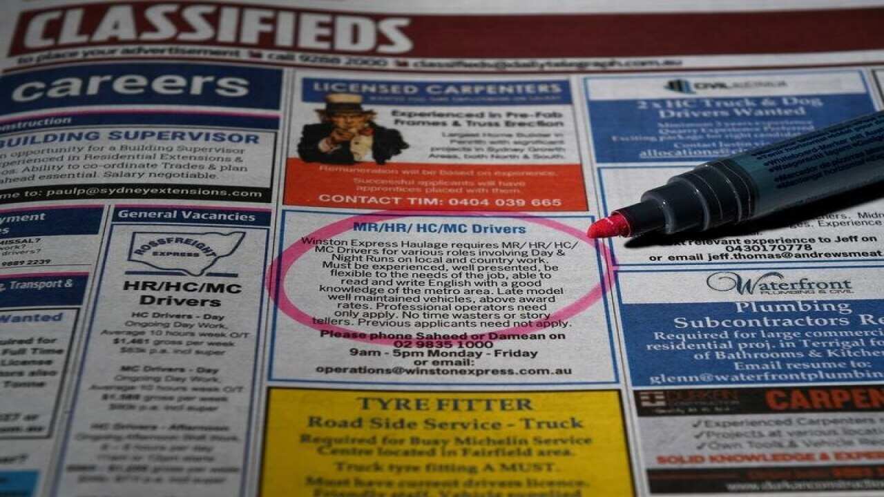 Job ads in a newspaper, circled, pen