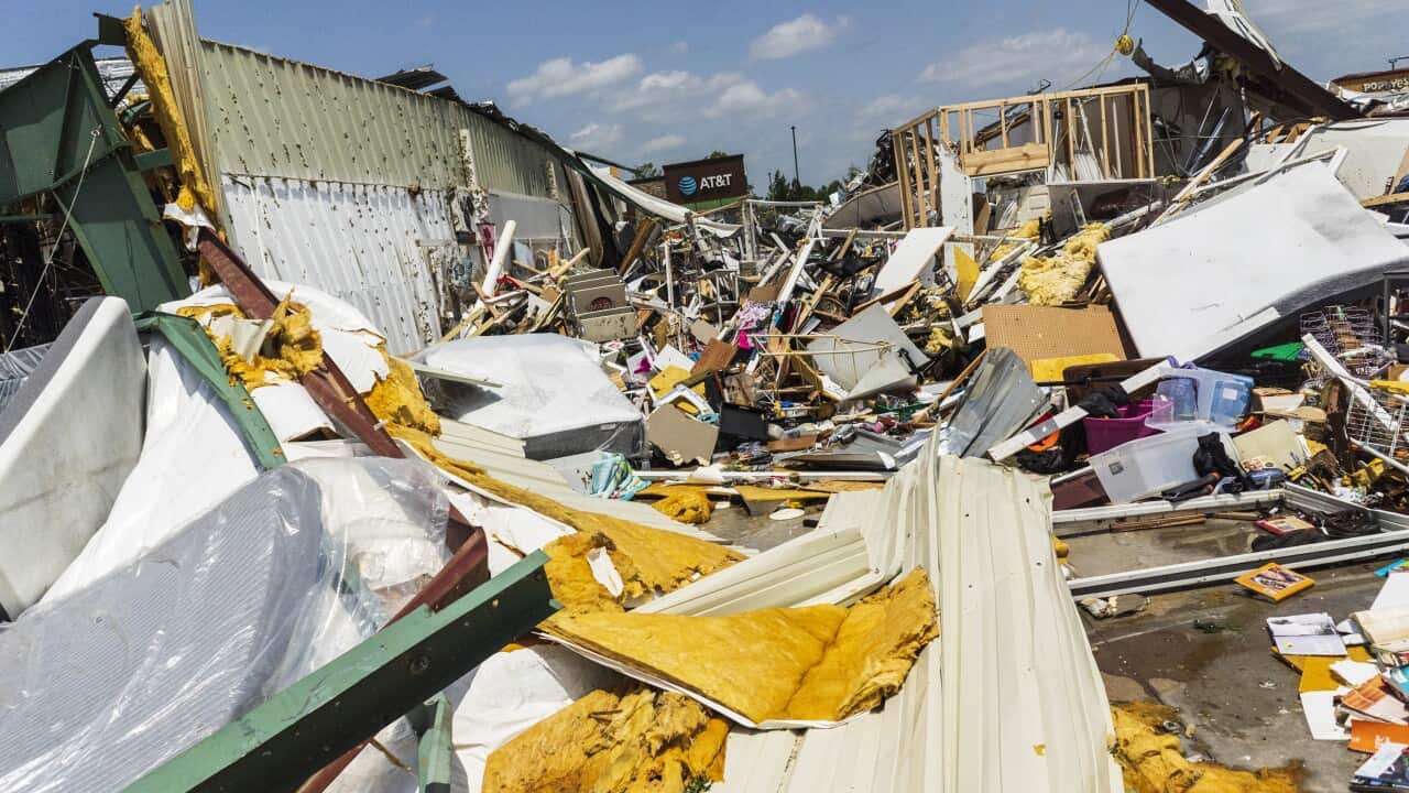 Severely damaged buildings with wreckage strewn about.