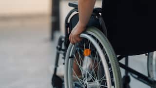 Patient using wheelchair moving in hospital courtyard