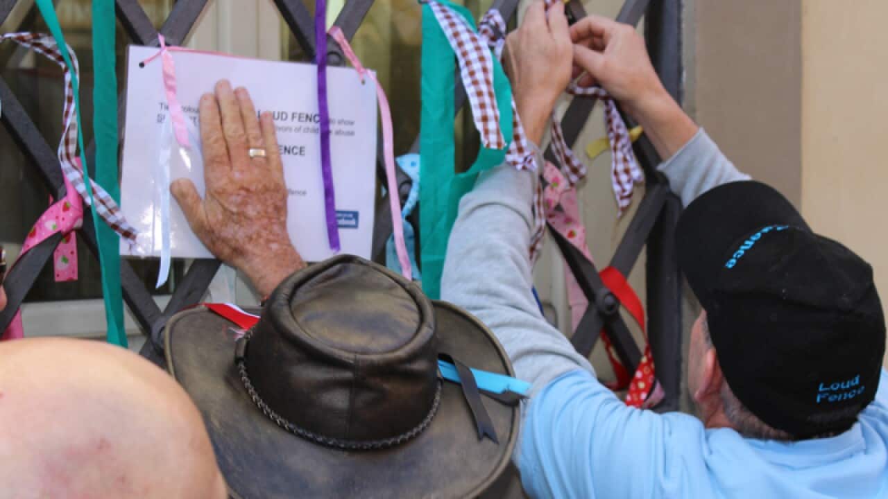 Abuse victims tie ribbons.