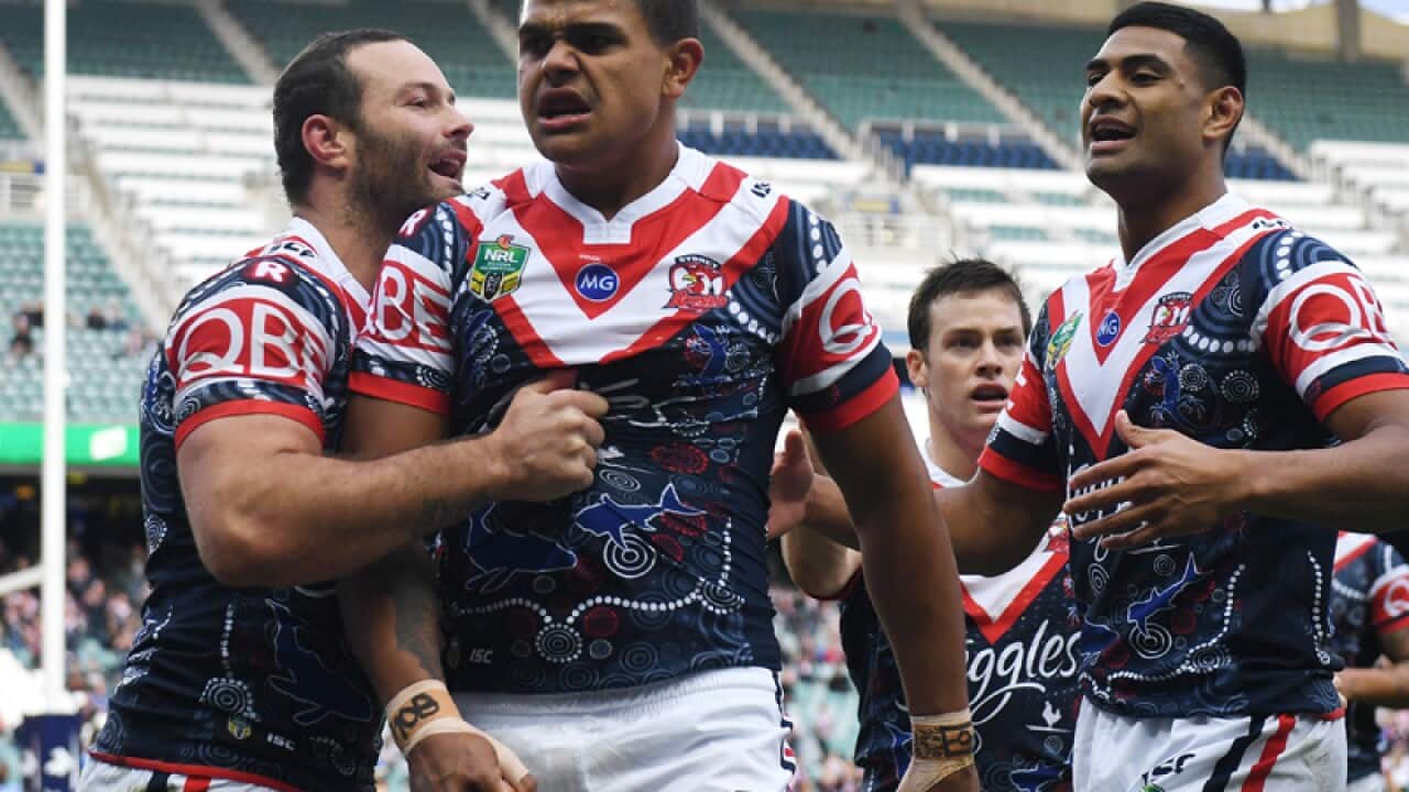 Mitchell (centre) of the Roosters is Cordner (right) Tupou