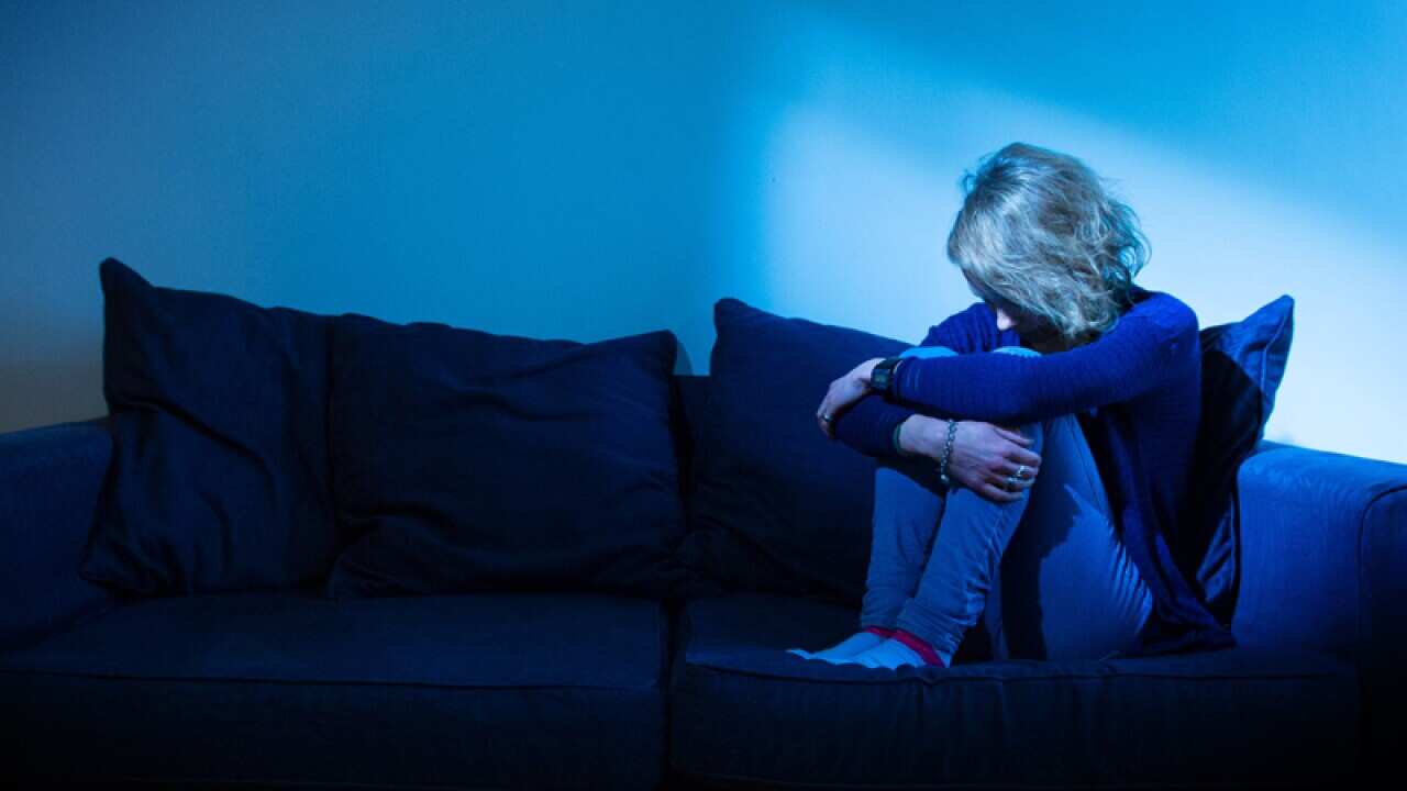 A woman poses for a photograph to illustrate depression