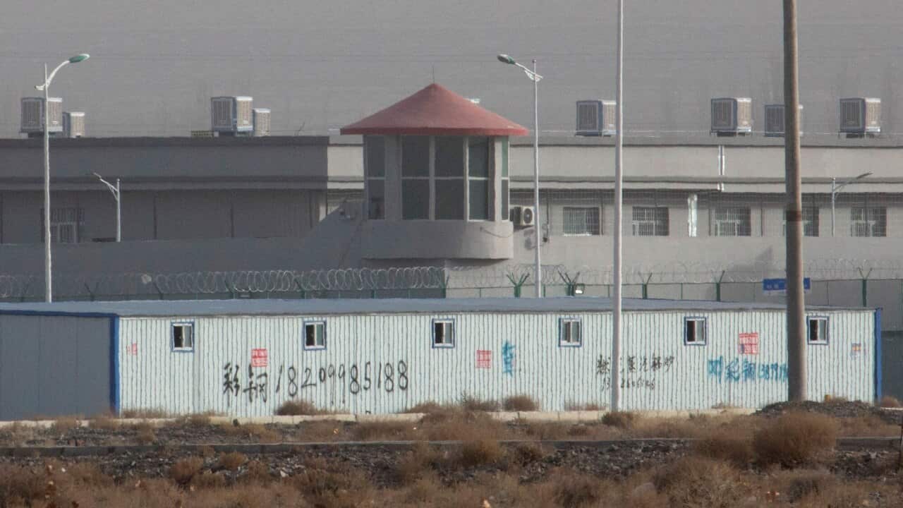 A guard tower and barbed wire fences are seen around a facility in the Kunshan Industrial Park in Artux in western China's Xinjiang region.