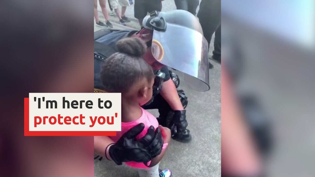 'I'm here to protect you' cop tells crying girl at Floyd protest