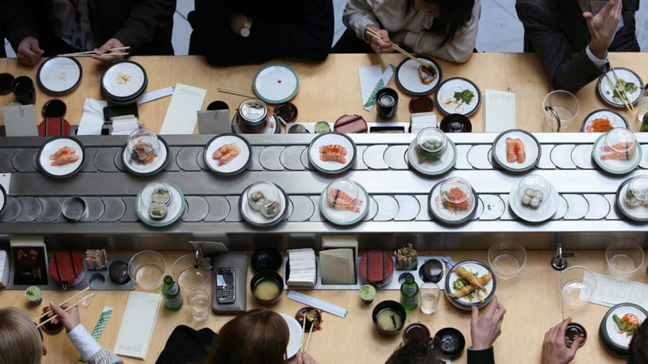Office workers eat Japanese food during their lunch break