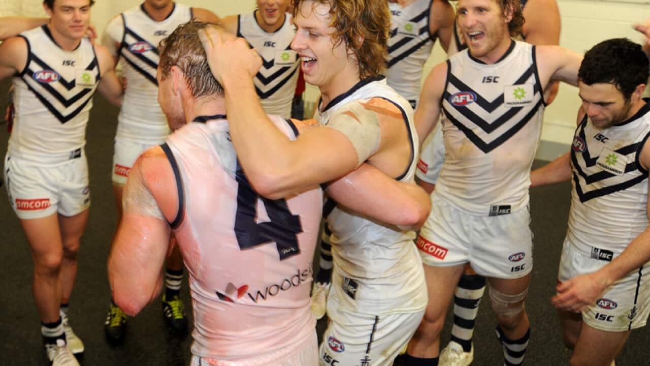 Fremantle celebrate winning against the Richmond Tigers