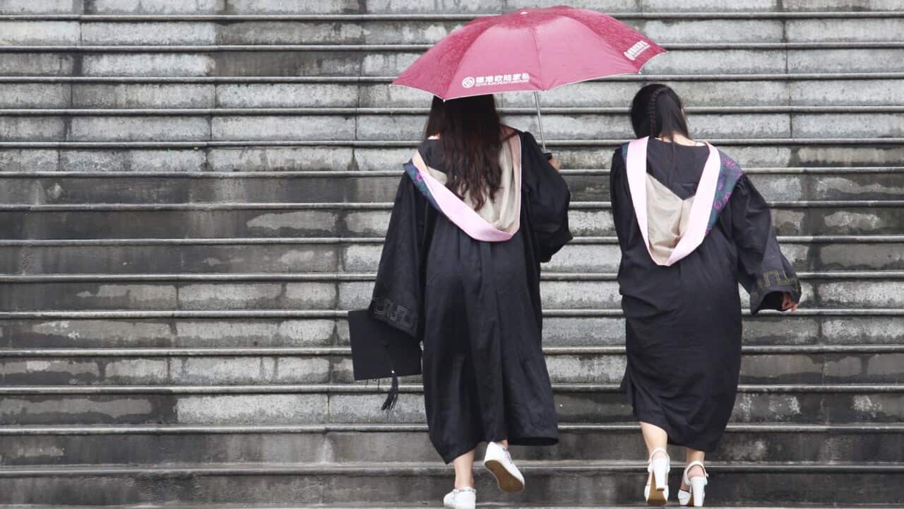 Femle students pose for graduating photograph in China
