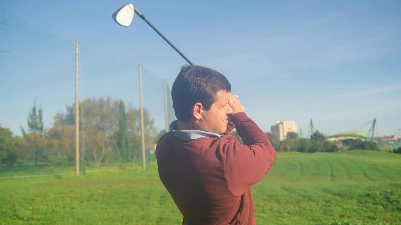 A representative image of a person playing golf.