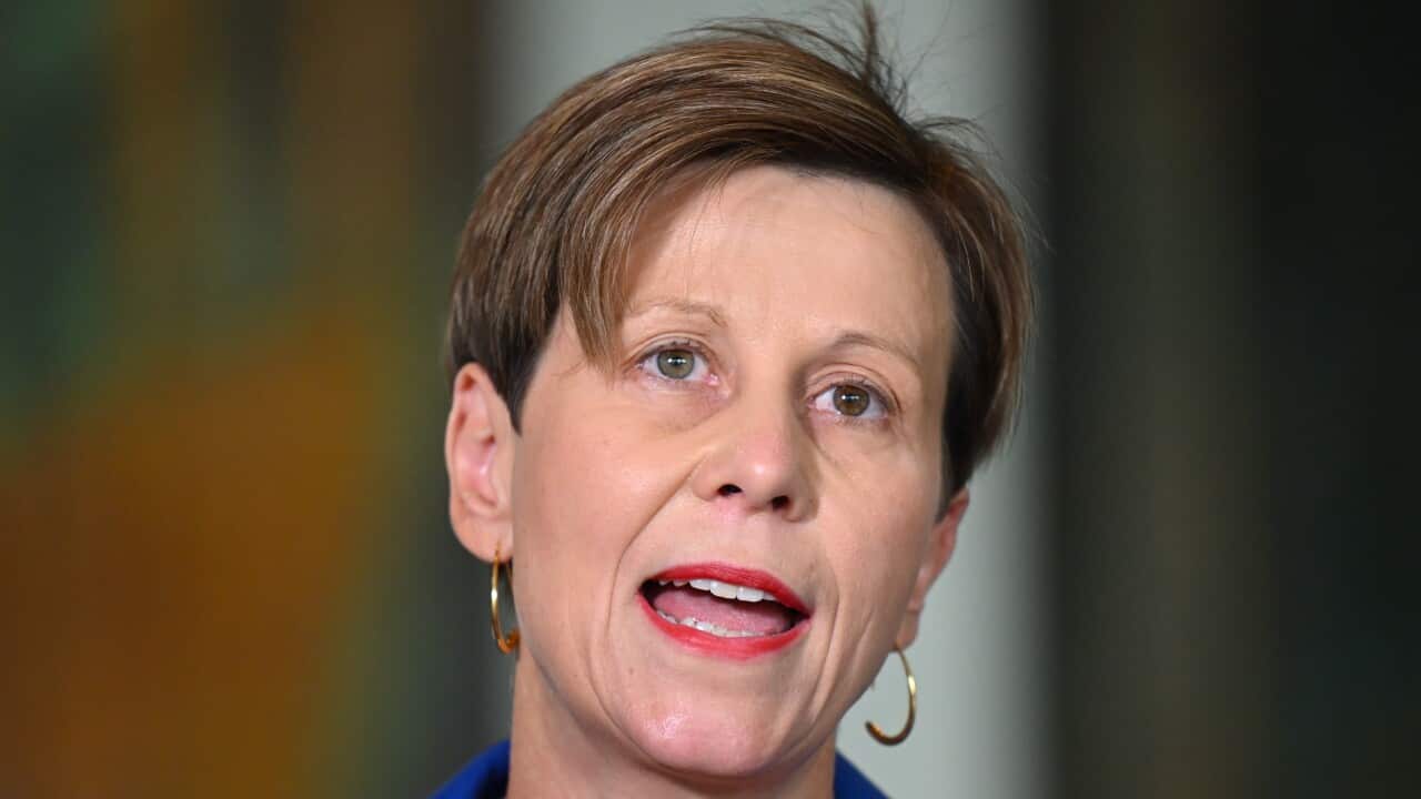 A close up shot of a woman wearing a blue jacket