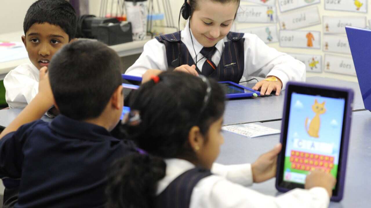 School children using tablets