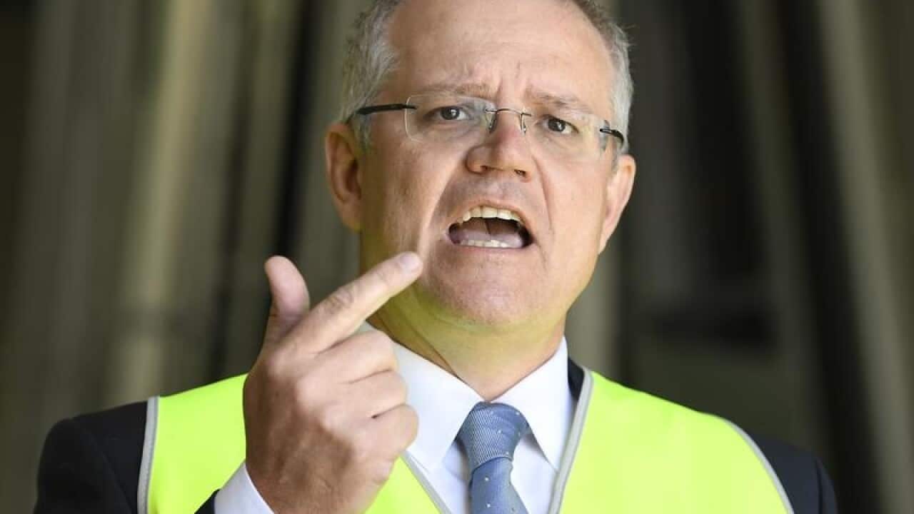 Federal Treasurer Scott Morrison gestures during a doorstop