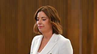 A woman in a white blazer