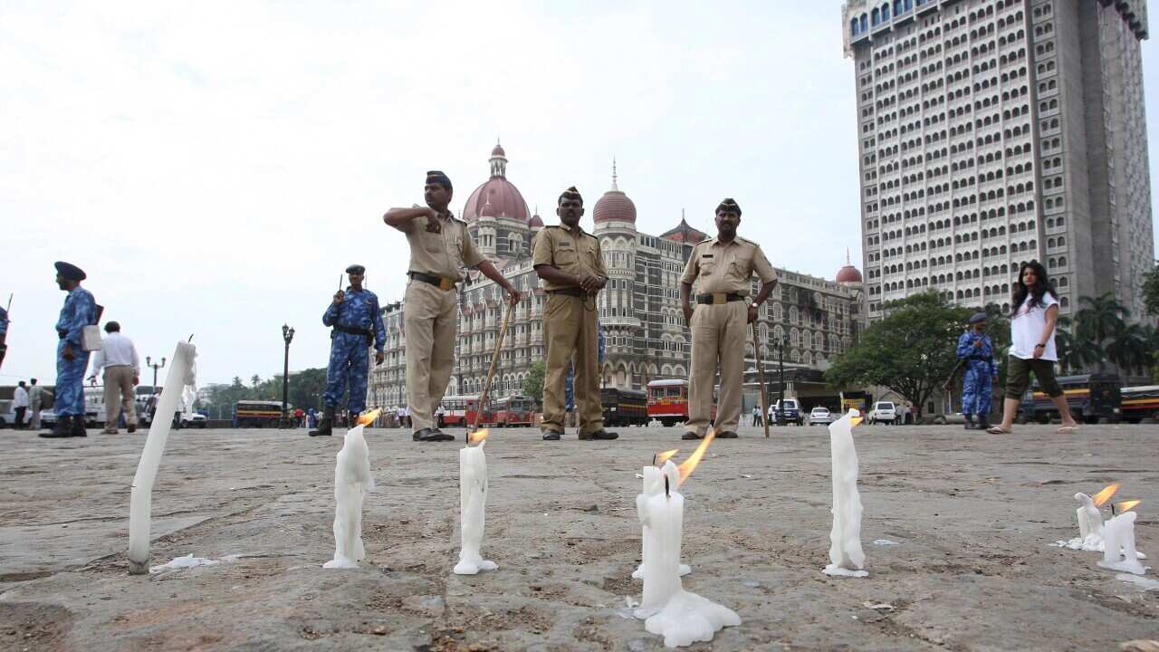 Candles burn outside the Taj Mahal Hotel in Mumbai 30 November 2008.