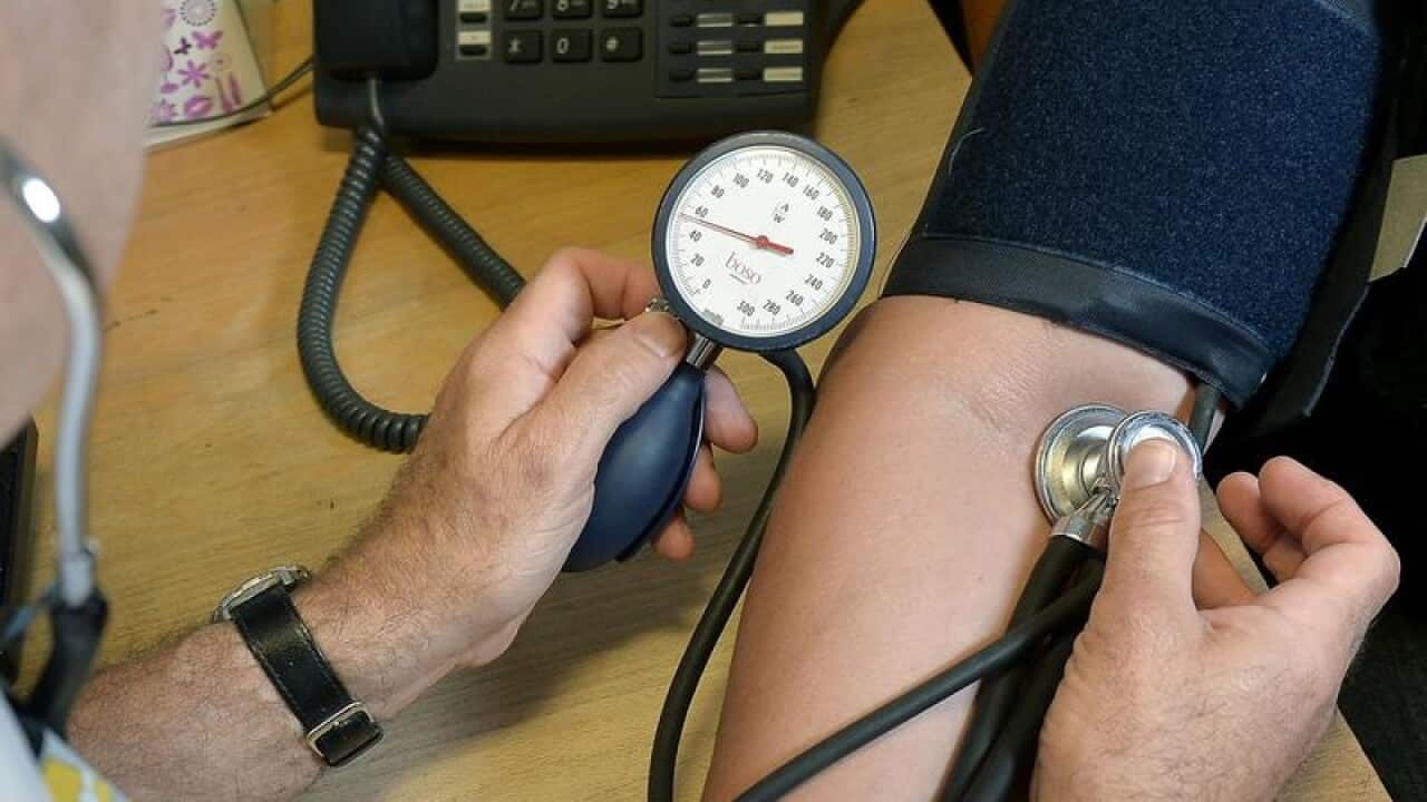 GP checking a patient's blood pressure