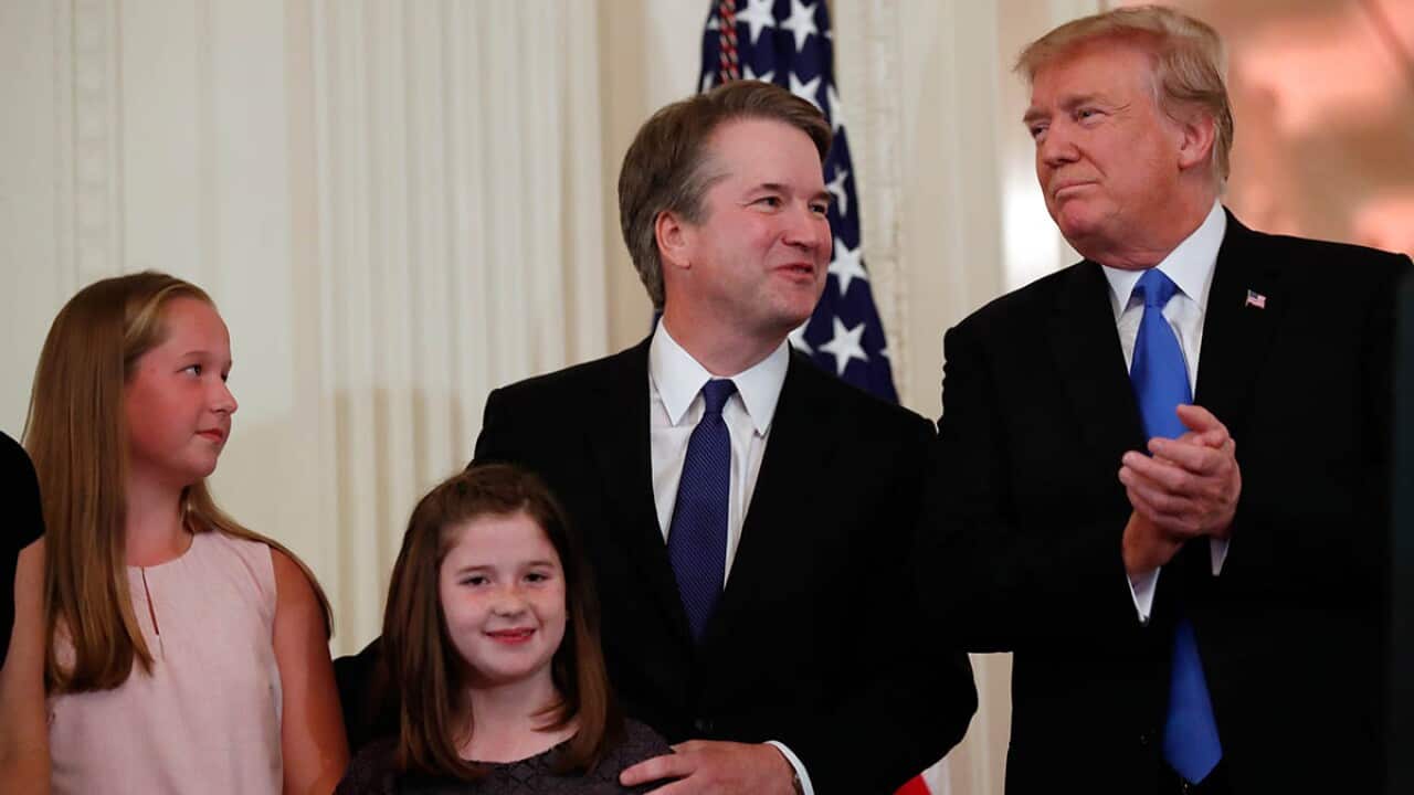 President Donald Trump stands with Judge Brett Kavanaugh his Supreme Court nominee, and his family.