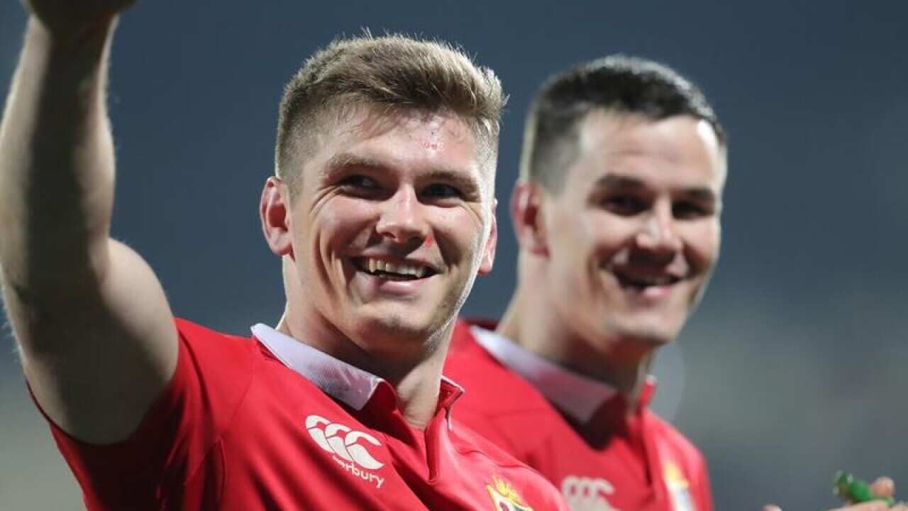 British and Irish Lions player Owen Farrell (L) and Johnny Sexton