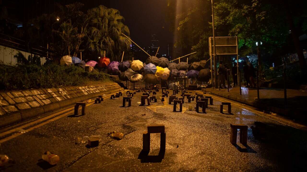 Umbrellas on a barricade mark one of the entrances to the Hong Kong Polytechnic University