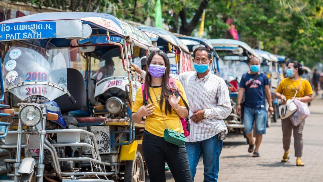 People wearing face masks are seen on the street in Vientiane, Laos, March 23, 2020 (Xinhua via Getty Images).jpg