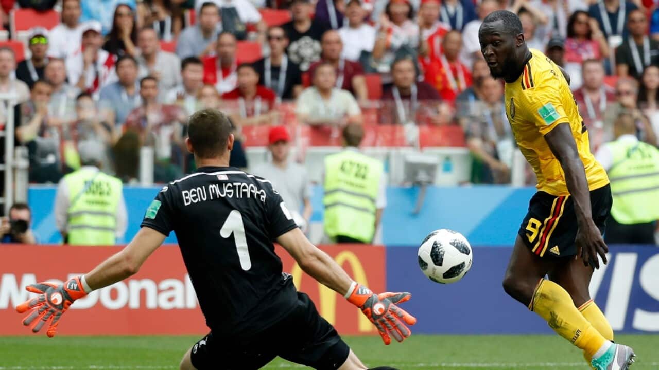Belgium's Romelu Lukaku, right, scores his side's third goal against Tunisia