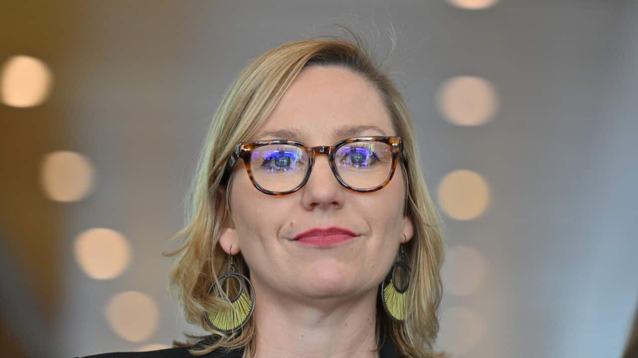 A blonde woman wearing glasses.