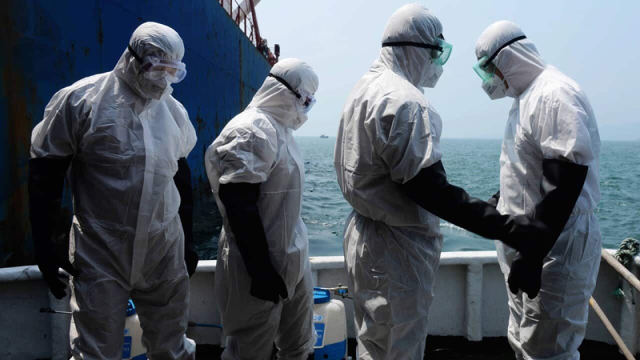 Chinese quarantine workers wearing protective clothing