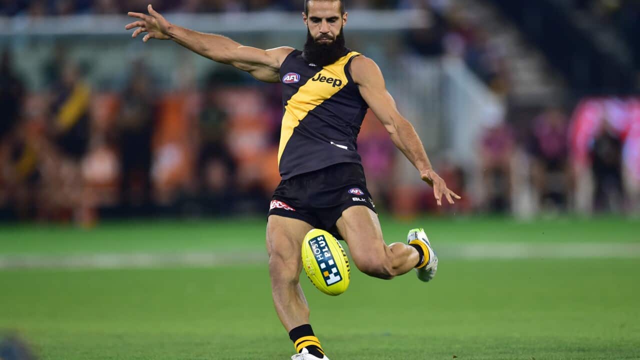 Tigers player Bachar Houli kicks as Richmond plays Melbourne at the MCG