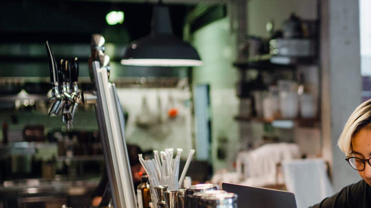 Young Asian female bartender working at the counter