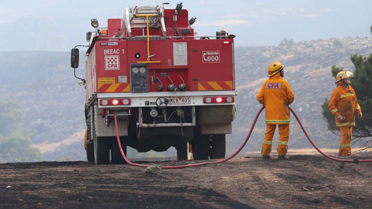Firefighters work to contain a bushfire near Scotsburn