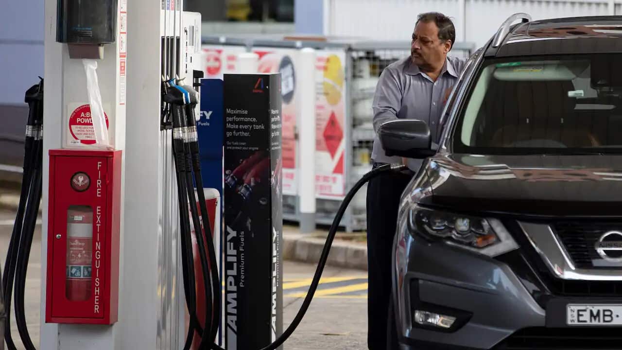 A man fills up his car at a petrol station in Sydney, Australia as fuel hits record prices in many areas across the country. 