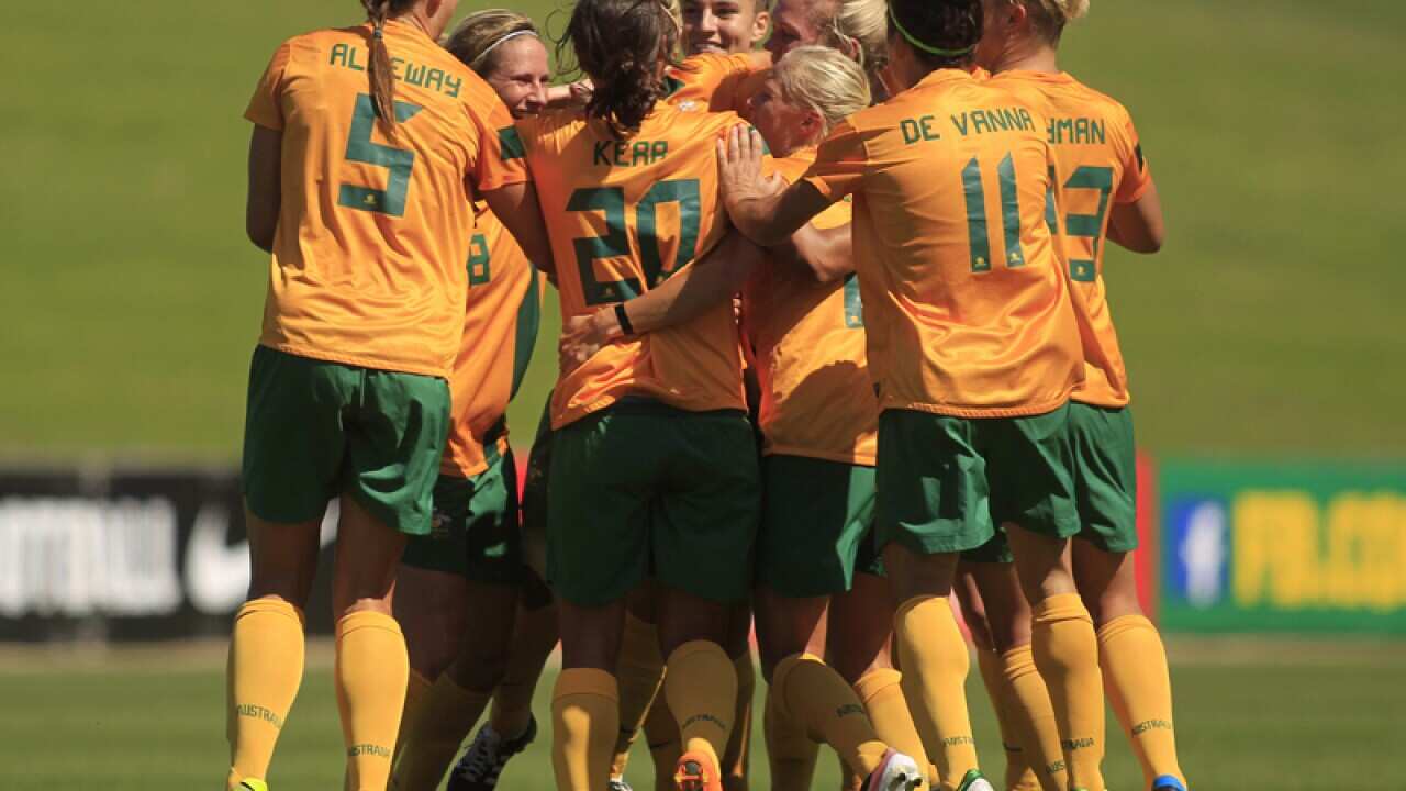 The Australian women's soccer team celebrate after scoring a goal