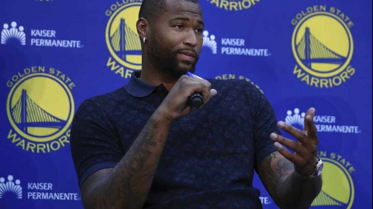 Golden State Warriors' DeMarcus Cousins gestures during a media event.