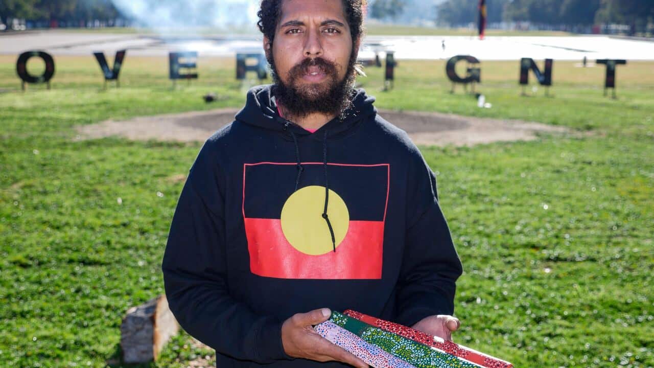 Alwyn Doolan pictured with message sticks