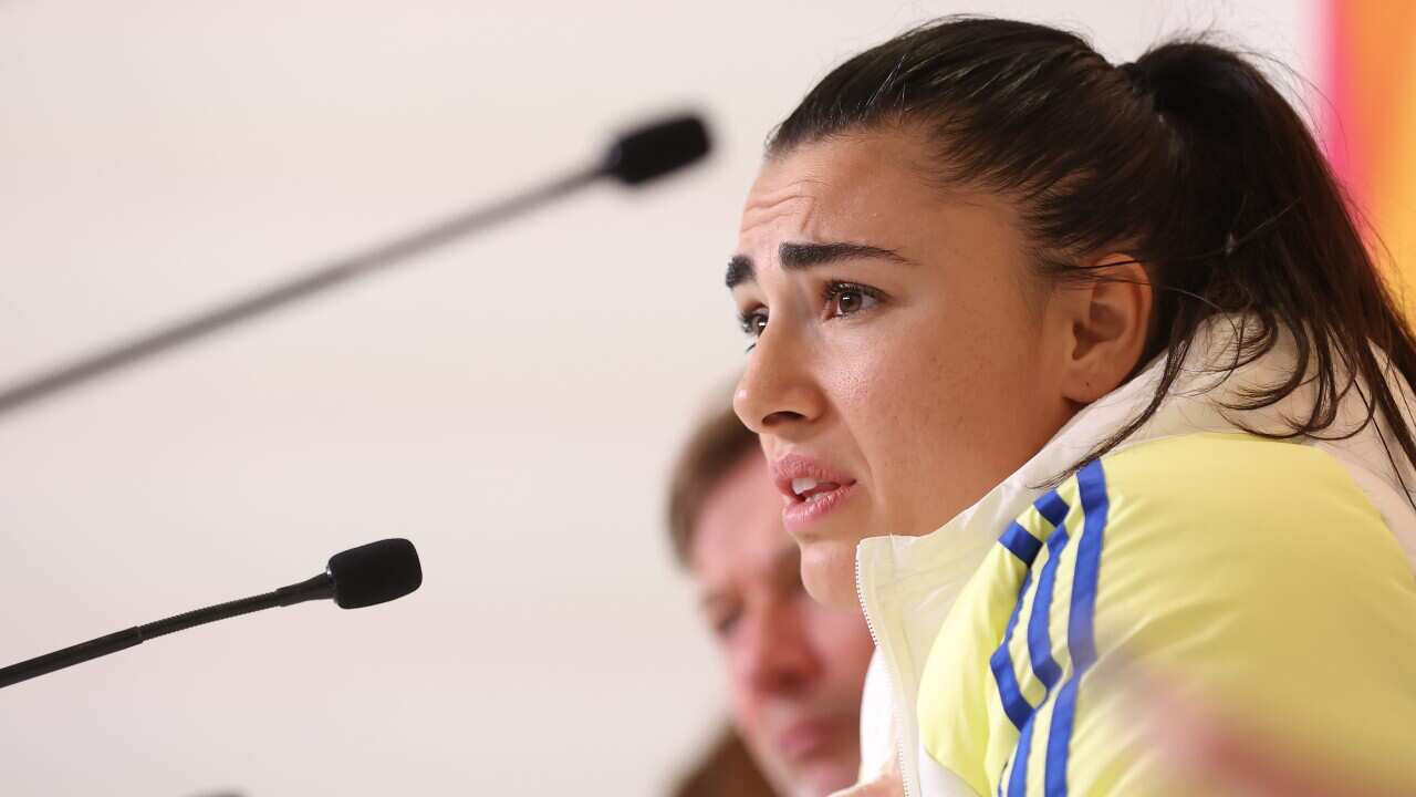 A female football player at a press conference