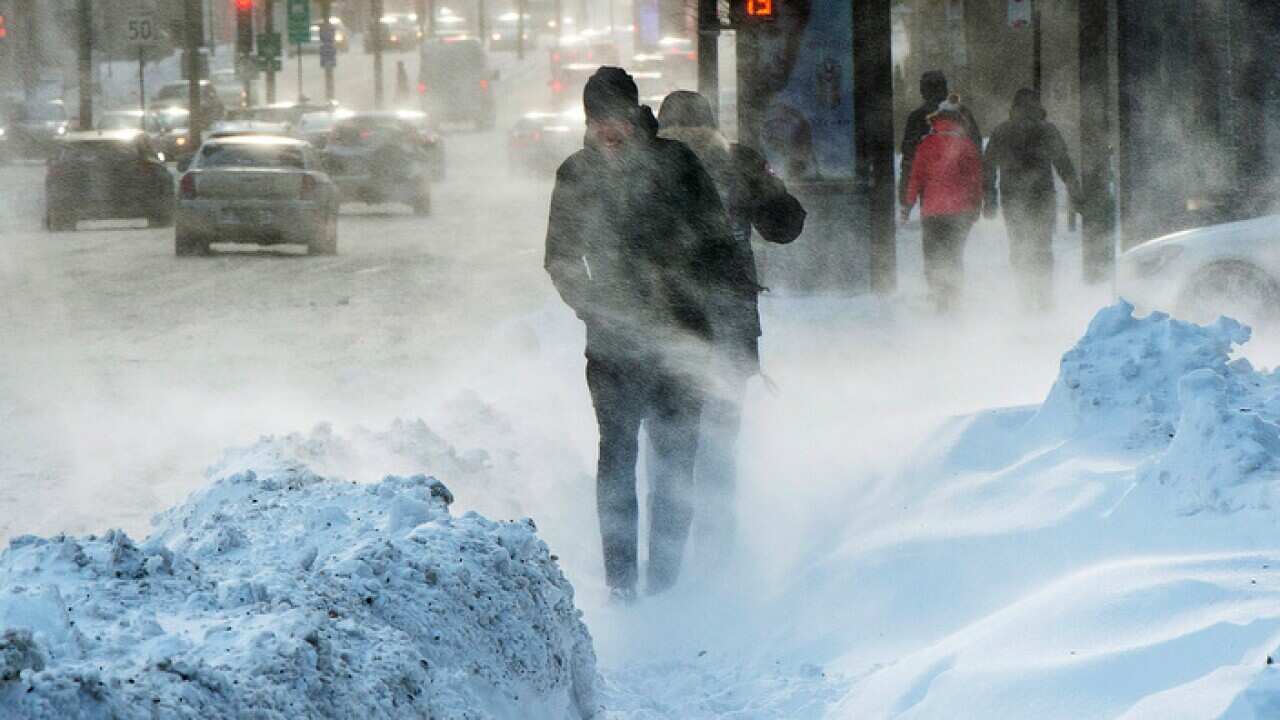 Pedestrians battle the blowing snow and wind chills around minus 30 degrees celsius (minus 22 degrees Fahrenheit), Friday, Jan. 5, 2018 in Montreal. (Ryan Remiorz/The Canadian Press via AP)