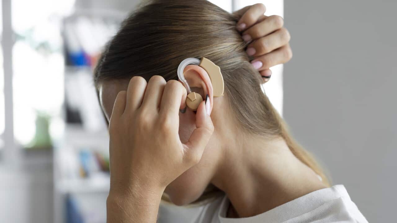 A woman wearing a hearing aid.