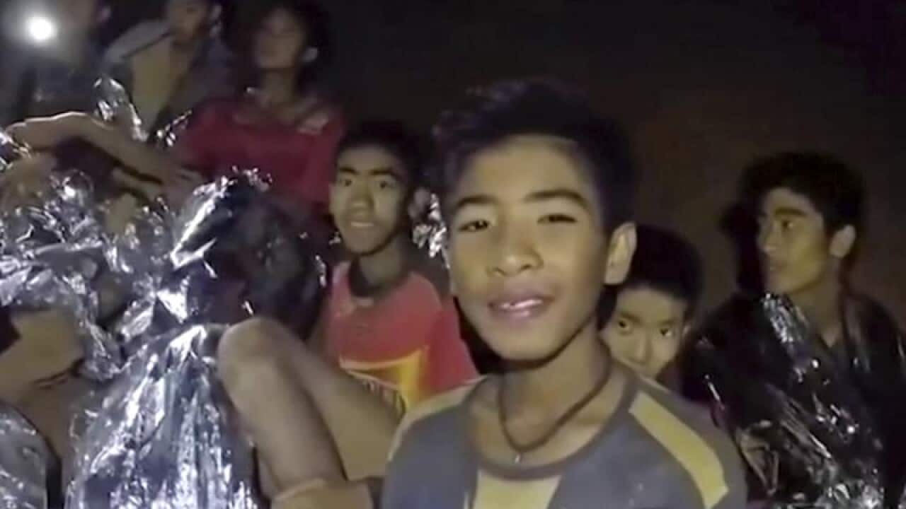Thai boys smile after being reached by Thai Navy Seal members.