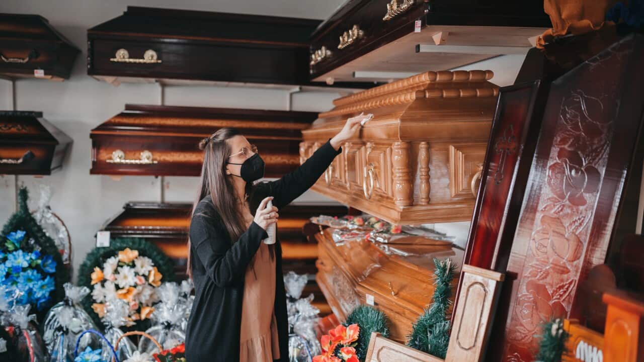 A worker cleans the funeral equipment shop