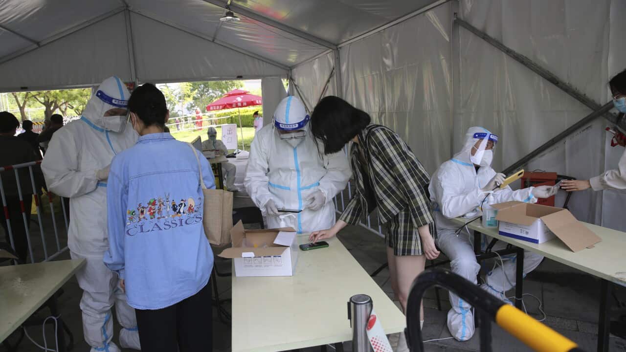 People standing getting PCR tests