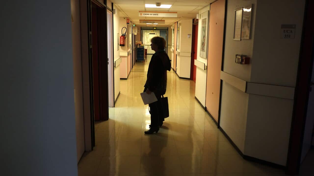 Person stands in dark corridor