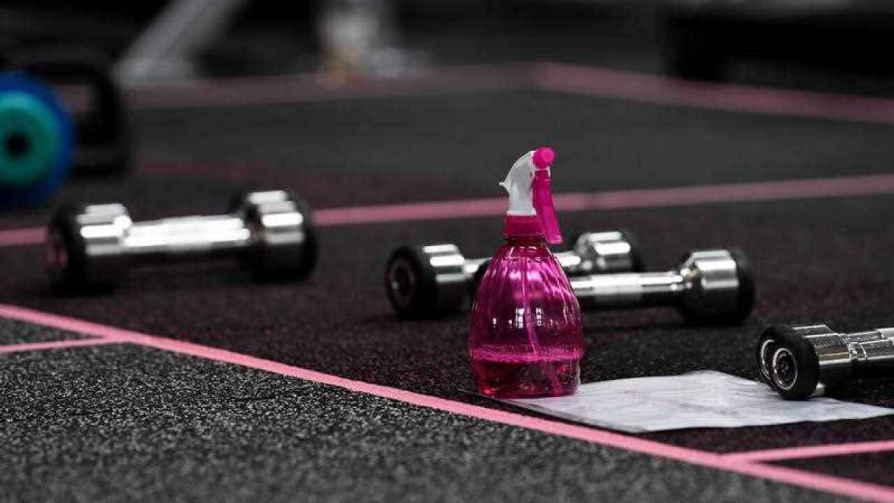 Disinfectant spray is placed around the gym for members to wipe down equipment at a gym in Sydney. 