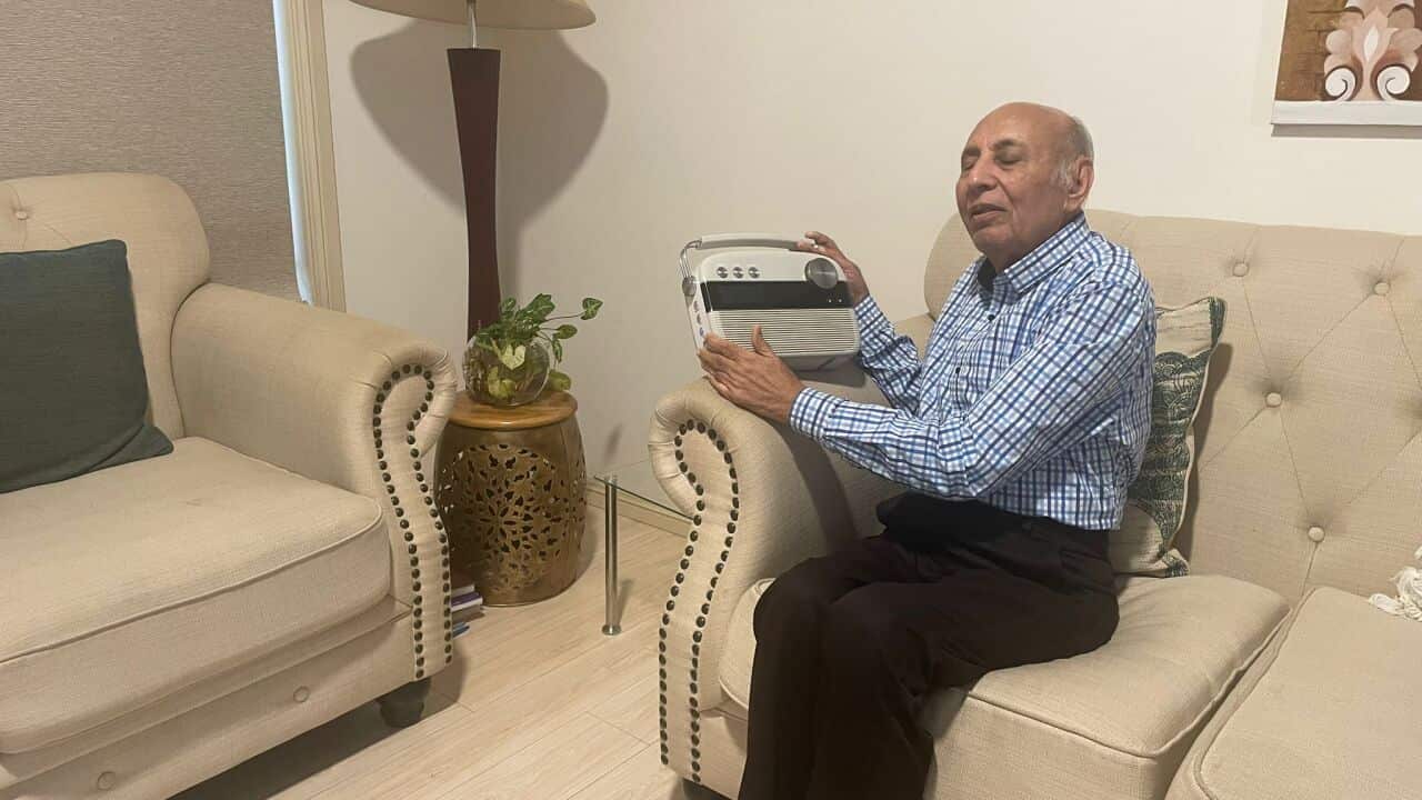 Dolarbhai Joshi is listening to SBS Gujarati program. Credit: Hemal Joshi